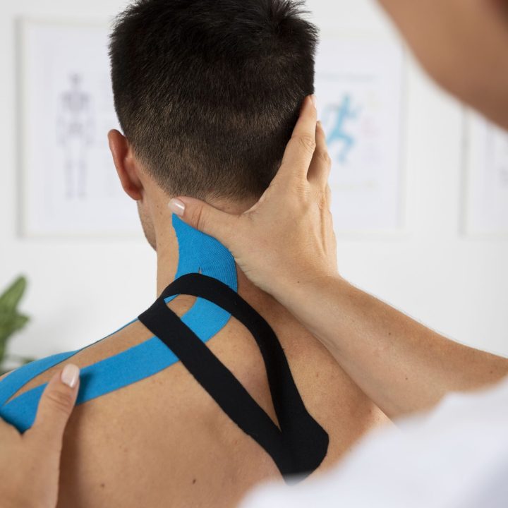 female-physiotherapist-applying-elastic-medical-bandage-male-patient-min