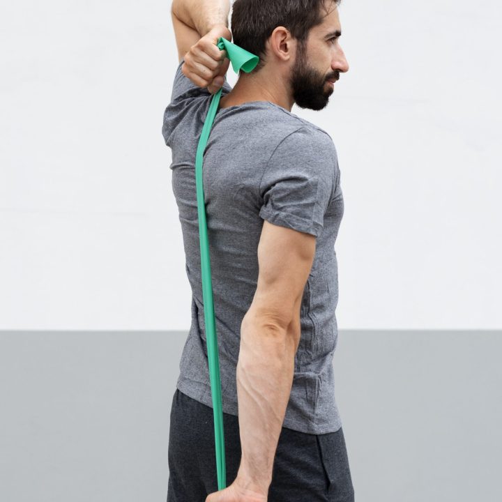 side-view-man-training-with-elastic-band-min